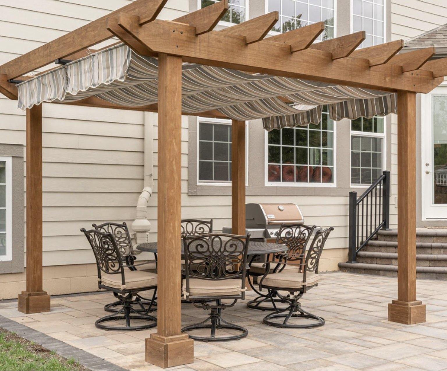 Broom-finished concrete patio beneath a wooden pergola