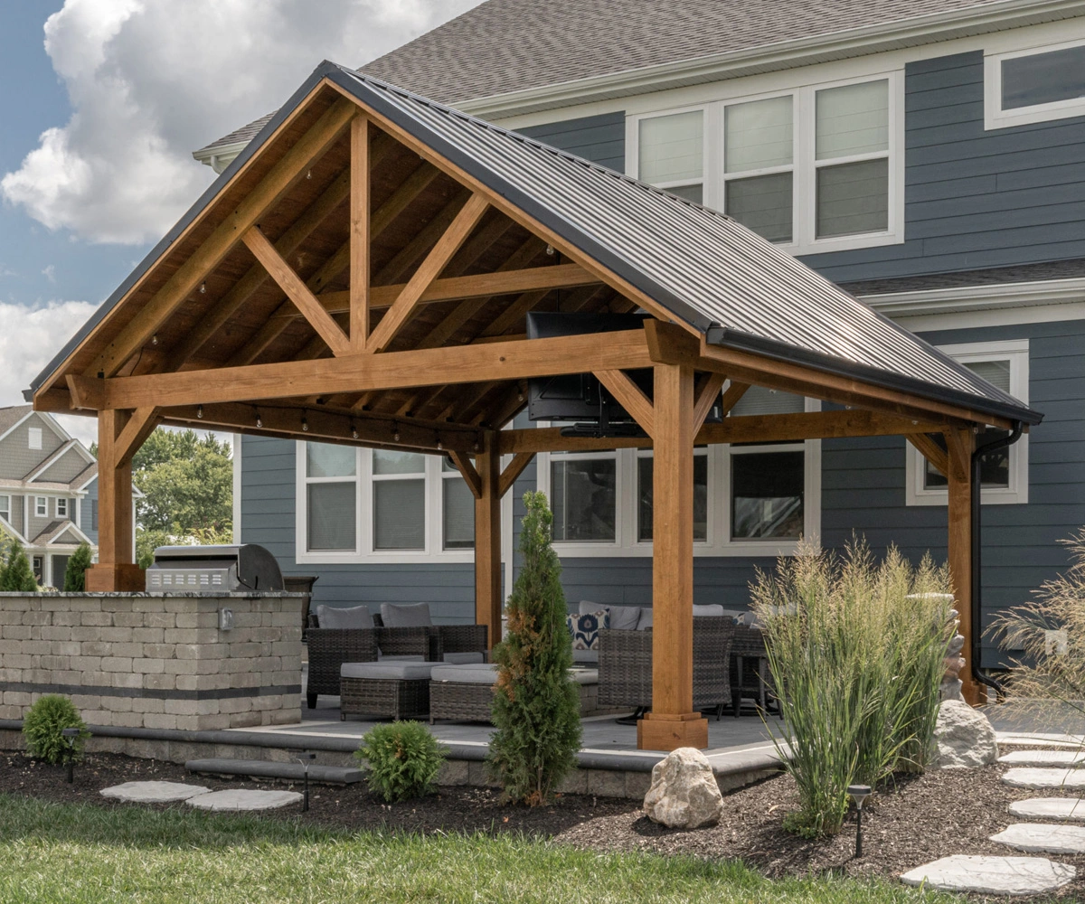 Wood pavilion with a gable roof installed in an outdoor living space
