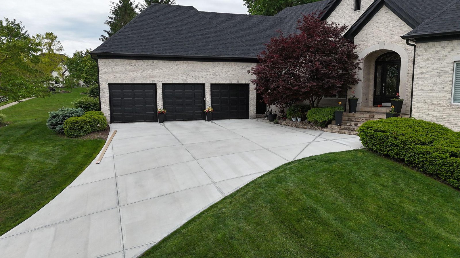 New residential concrete driveway with clean broom finish in Carmel Indiana