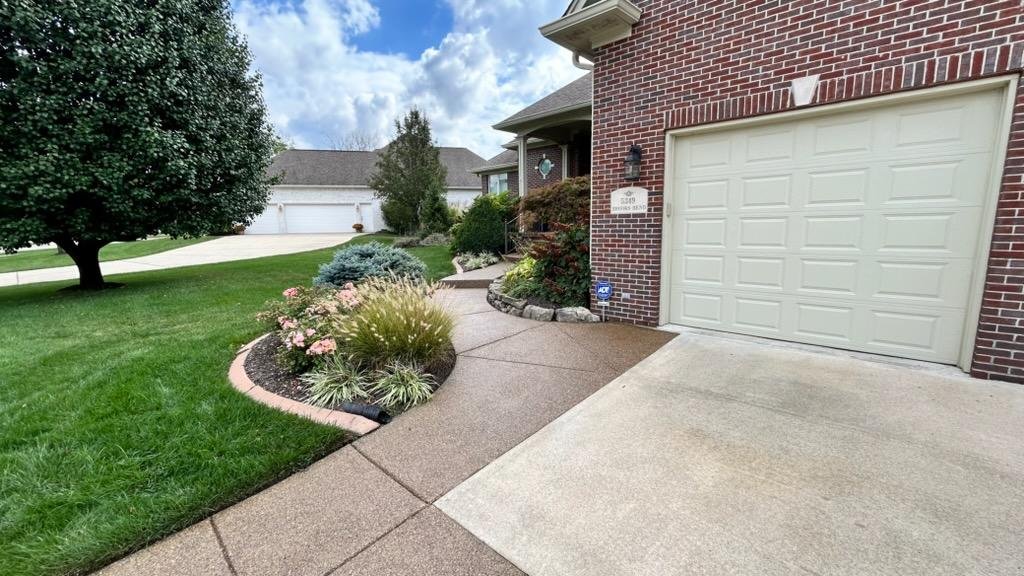 Cleaned and sealed concrete patio with an even finished appearance