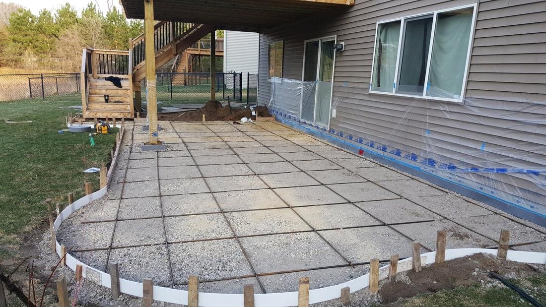 Concrete Indy crew placing and broom-finishing a new patio