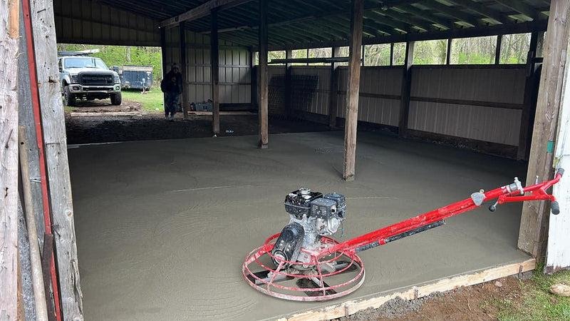 Pole barn interior being measured for a concrete floor estimate